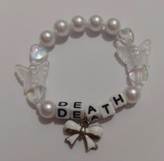 My death inspired bracelet for the trilogy tour ! (Not for trade)    #melaniemartinez #trilogytour #bracelets #handmade #portals #k12 #crybaby #extraclutterep #afterschoolep #aftershcool #extraclutter #dollhouseep #dollhouse #concert #melanie #mel #fairy #faerie #lyrics #songs #music #fairycore #necklace Music Inspired Bracelets, Melanie Martinez Inspired Bracelet, Song Bracelet Ideas, Bracelet Ideas Melanie Martinez, Melanie Martinez Trilogy Tour Bracelets, Melanie Martinez Friendship Bracelet, Trilogy Tour Bracelets, Cool Kandi Ideas