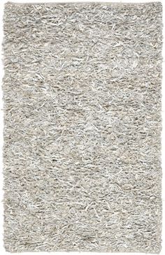 an area rug with white shag on the top and bottom, in various sizes