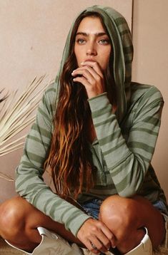 Stay ahead of the fashion game with our Stripe Up Olive Hooded Top by Bucketlist. Featuring a relaxed fit, button down front, and trendy hoodie, this top is perfect for any casual occasion. Plus, the raw edge details add a touch of uniqueness to your look. Get ready to slay in style! Casual Spring Hoodie Top, Casual Green Hooded Top With Drawstring, Casual Green Top With Drawstring Hood, Casual Green Hoodie For Loungewear, Casual Everyday Hoodie Top, Casual Loungewear Hoodie, Casual Hoodie For Loungewear, Casual Hoodie For Fall Loungewear, Casual Cotton Tops With Drawstring Hood