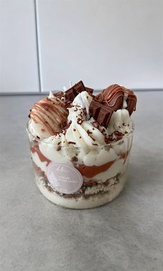 a dessert with chocolate, cream and whipped cream on top is sitting on the counter