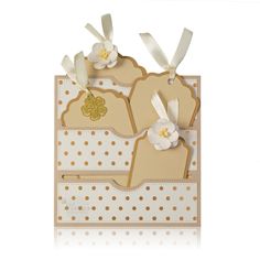 two tags with flowers on them are attached to the side of a card that has polka dots