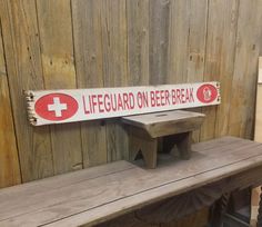 a bench with a lifeguard on beer break sign