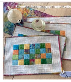 three quilted placemats sitting on top of each other