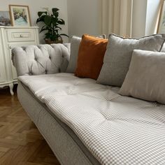 a couch with several pillows on top of it