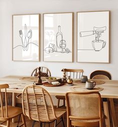 a dining room table with chairs and pictures on the wall