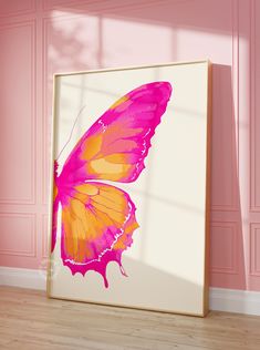 a pink and yellow butterfly on a white wall in a room with pink walls, hardwood floors and wooden flooring