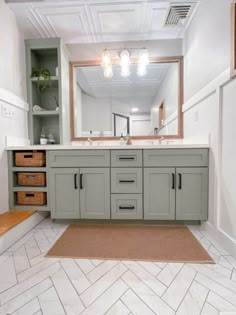 a bathroom with two sinks and a large mirror