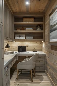 a home office with wood paneling and built - in shelving, including a desk