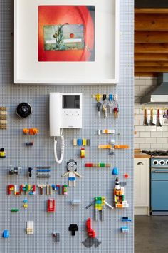 a kitchen wall with legos on it and a phone hanging up against the wall