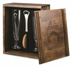 an open wooden box with two glasses and a bottle opener in the bottom right hand corner