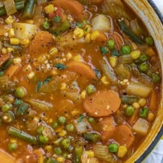 a bowl filled with vegetable soup on top of a table