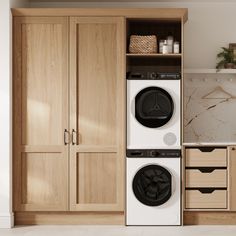 a washer and dryer in a room with wooden cabinets on either side of it