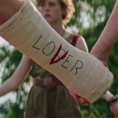 two people holding hands with the word lover written on them