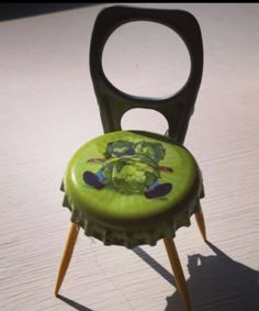 there is a green chair that has been decorated with images on the back and sides