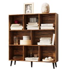 a wooden shelf with books and pictures on it