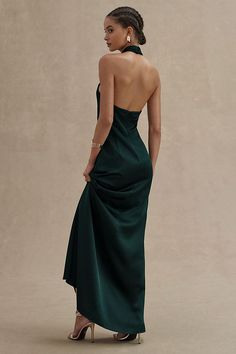 a woman in a green dress looking back