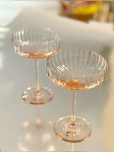 three wine glasses sitting on top of a table