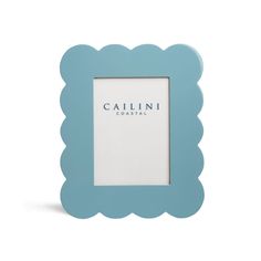 a blue scalloped frame with the word caulini coastal on it's side