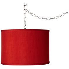 a red lampshade hanging from a chain