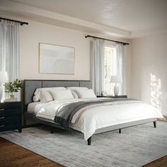 a bedroom with a large bed and two nightstands