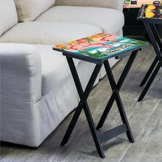 two tables sitting on top of a wooden floor next to a couch and coffee table