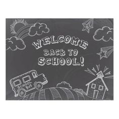 a chalkboard with the words welcome back to school written on it