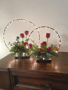 two vases filled with flowers on top of a wooden table