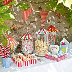 a table topped with lots of candy and popcorn