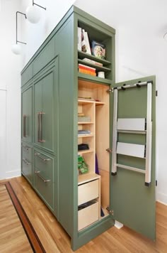 an open cabinet in the middle of a wooden floor