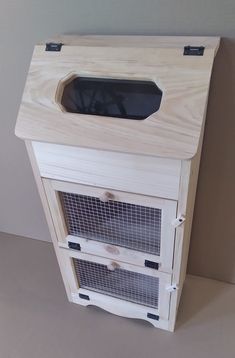 a wooden cabinet with two cages on top