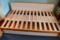 a bed frame made out of wooden slats