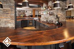 a kitchen with an island made out of wooden planks and lights hanging from the ceiling