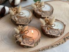 small candles are placed on wood slices with twine and burlocks tied around them