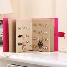 a pink case holds several pairs of earrings