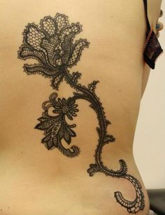 the back of a woman's stomach with an intricate design on it