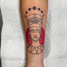 a woman's arm with a tattoo on it and a red circle behind her