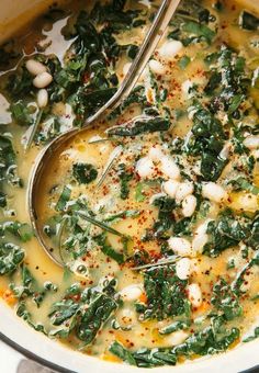 a bowl filled with greens and white beans