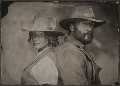 an old photo of two people wearing hats