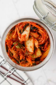 a glass jar filled with food on top of a table