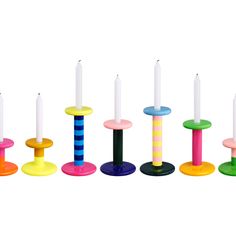 several candles are lined up in different colors