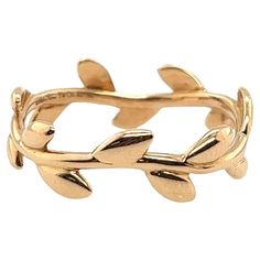 Elevate your style with this exquisite Tiffany & Co Paloma Picasso Olive Leaf Band in 18ct Rose Gold. The delicate design of the olive leaves wrapped around the band symbolizes peace and harmony, making it a perfect accessory for any occasion. • Width of Band: 7.4mm • Total Weight: 2.7g • Ring Size: S 1/2 NS0070 Tiffany And Co Olive Leaf Ring, Paloma Picasso Olive Leaf Ring, Cuff Bracelets Gold Tiffany & Co., Tiffany Atlas Ring, Olive Leaf Ring, Paloma Picasso, Olive Leaf, Leaf Ring, Leaf Jewelry