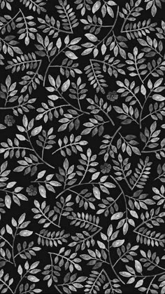 a black background with silver leaves on it