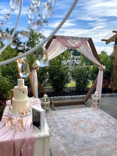 a wedding cake sitting on top of a table next to a white and pink rug