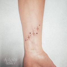 a small star tattoo on the foot of a woman's left foot, with stars in it