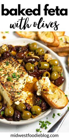 baked feta with olives on a white plate and bread in the background text reads baked feta with olives