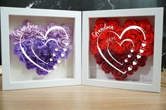 two framed paper hearts with the words grandma and grandpa written on them in white frames