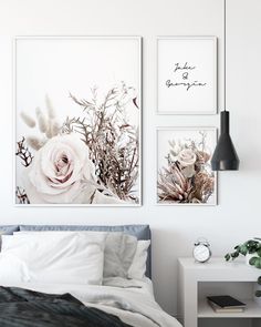 three framed pictures hang on the wall above a bed