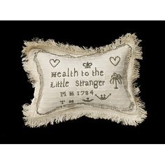 an embroidered pillow with the words, health to the little strange