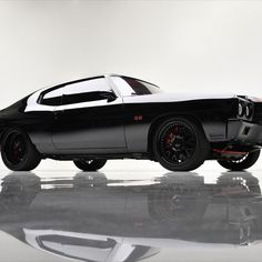 a black and white muscle car on a reflective surface