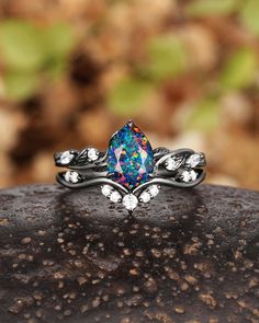 ► FEATURES Rhodium black gold plating pear shape opal engagement ring set, black facet opal bridal set, black promise ring, black wedding ring, gothic black anniversary ring set, unique witchy opal wedding ring gift for women, wife, mom, girlfriend, girl, best friend. Rhodium black plating: Rhodium is a precious metal that is in the family of platinum. There are many upsides of rhodium plated jewelry. Engagement Ring: Center Stone:  Black Opal Size: 6x8mm Pear Shape Side Stone: Clear Moissanite Black Opal Engagement Ring, Fire Opal Engagement Ring, Black Fire Opal, Floral Wedding Ring, Opal Engagement Ring Set, Anniversary Ring Set, Australian Opal Ring, Black Gold Ring, Opal Engagement Ring